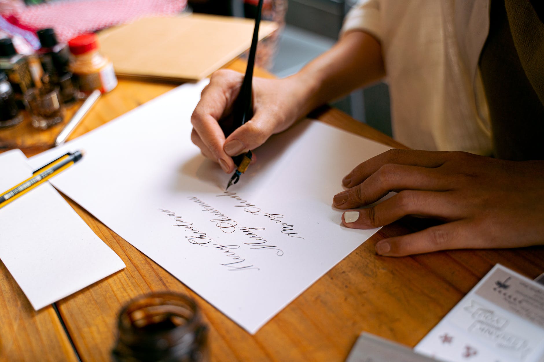 a calligrapher writing on a paper